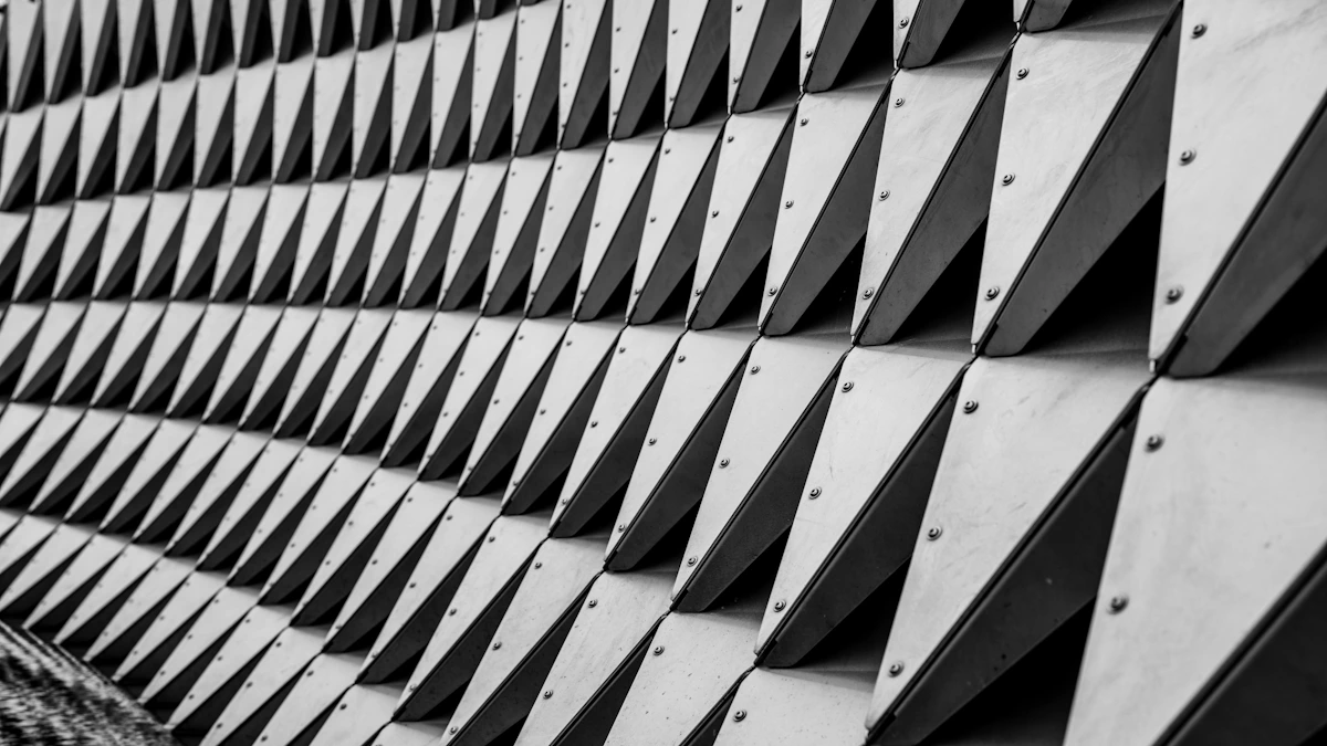 Stacked structural steel plates with visible mill marking stamps in a clean warehouse.